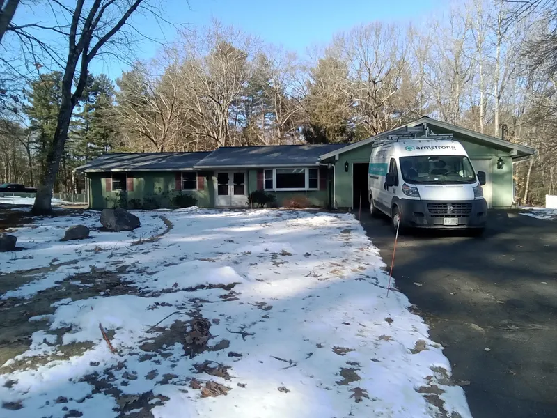 Armstrong service van parked in a homeowner's driveway for an air duct cleaning appointment.