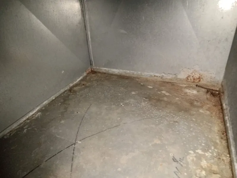 Bare sheet metal inside a duct plenum after Armstrong removed the built-up dust and debris.