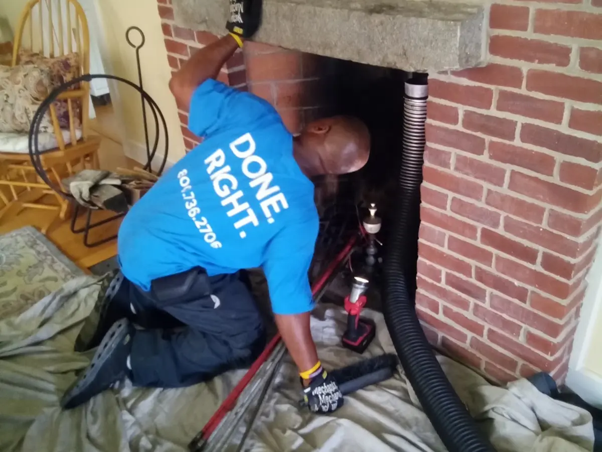 Armstrong technician power-sweeping a home chimney flue