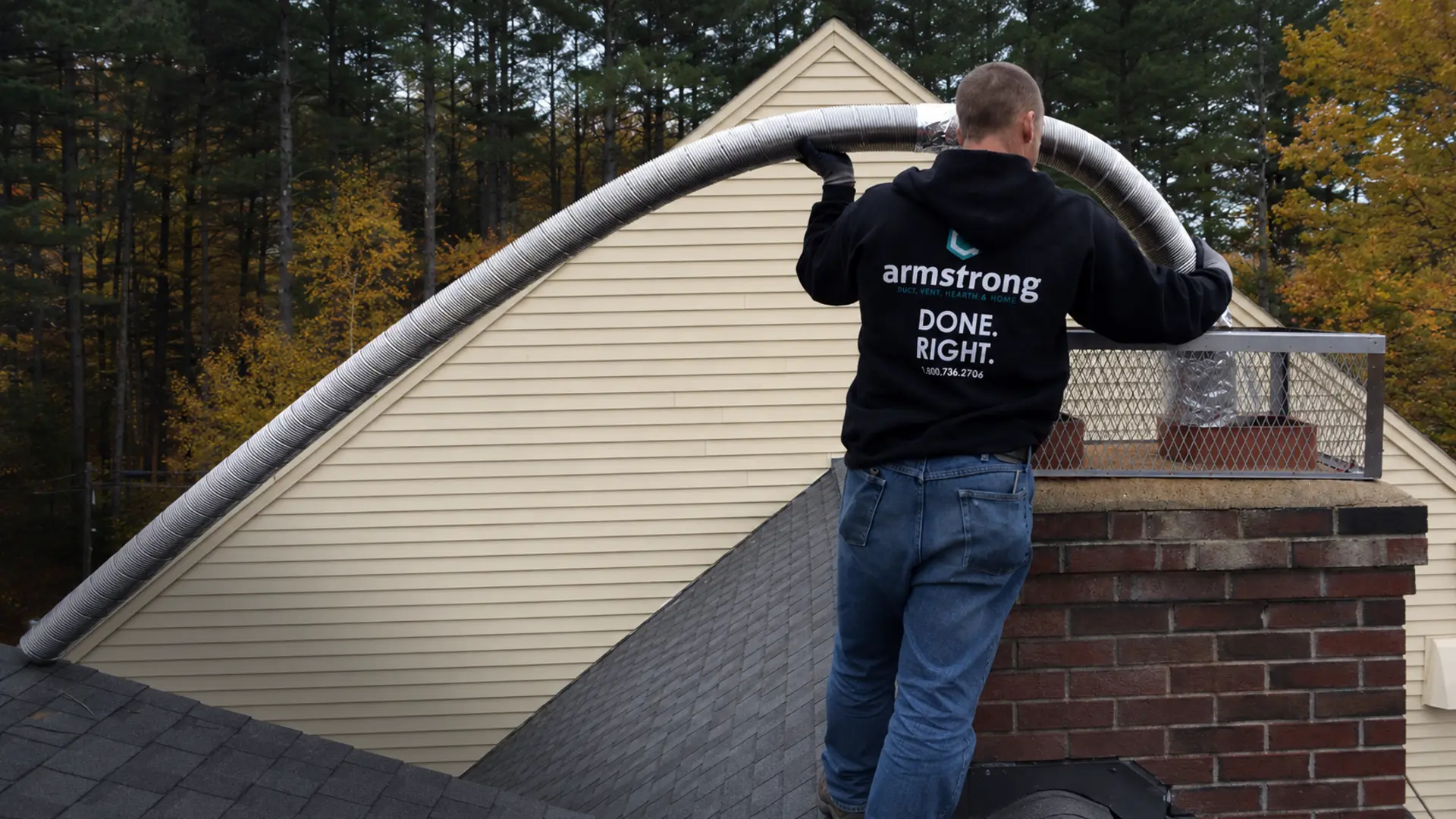 Armstrong technician repairing brick chimney masonry and installing a stainless steel chimney liner
